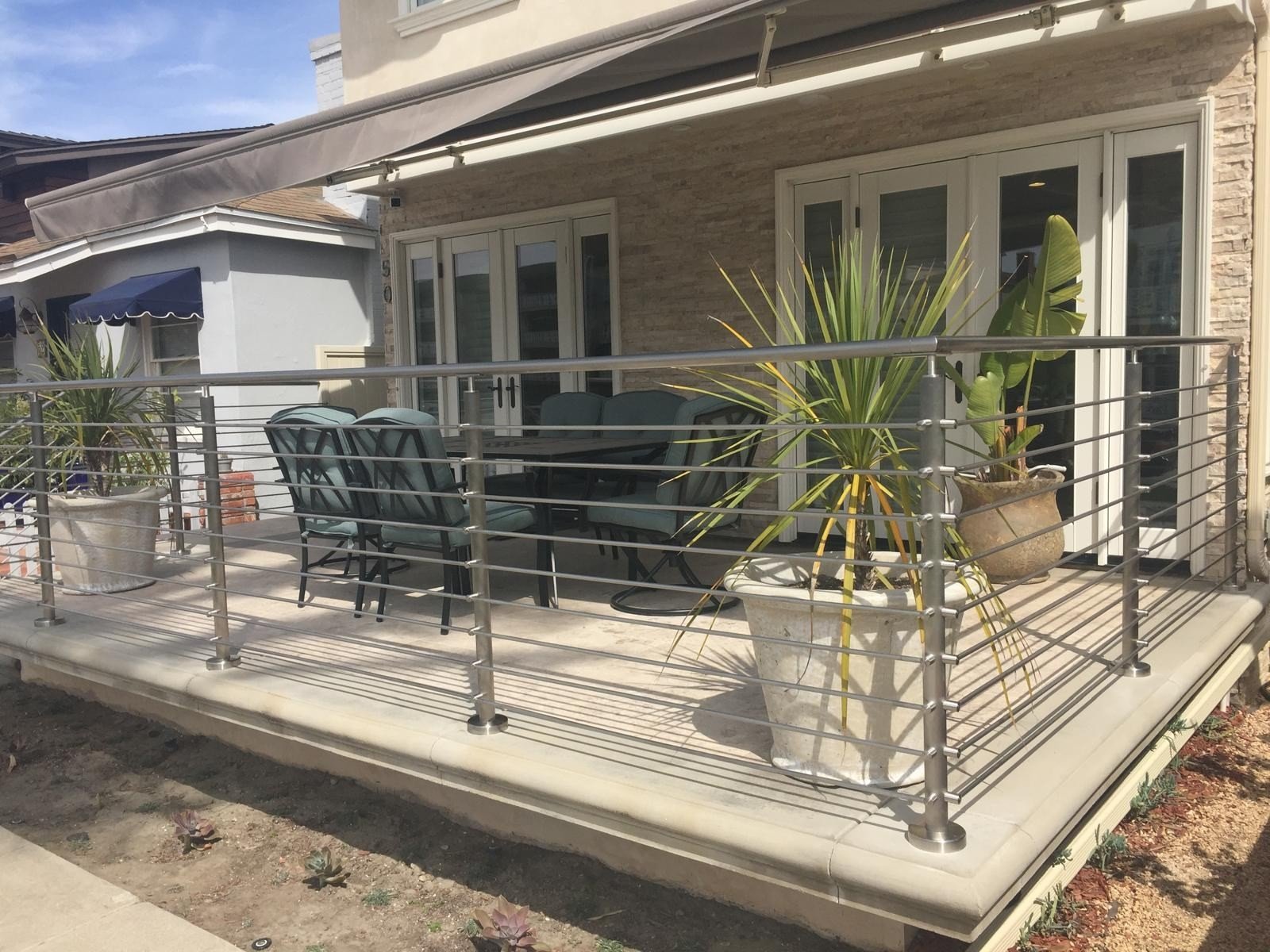 Continuous stainless cable railing across multiple stepped deck levels on a Malibu hillside property