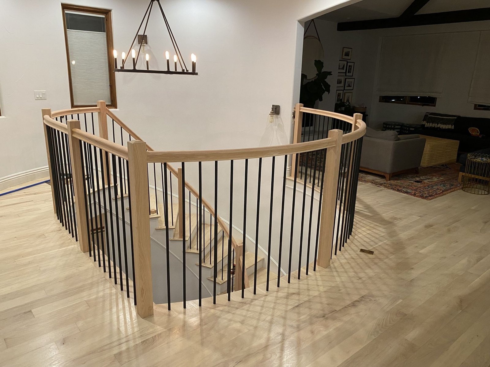 Curved Oak Balcony Balustrade Overlooking a Newport Coast Great Room